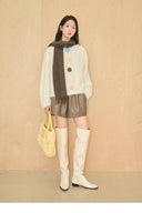 Cream fuzzy reversible sweater with hand-crocheted 3D flowers — minimalist winter knitwear.