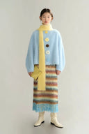 Model wearing reversible fuzzy blue sweater with crochet flowers — soft winter aesthetic outfit.