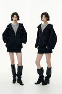 Two identical outfits with a black jacket, skirt, and boots on a white background