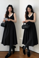 Two model views of a black cotton knit midi dress with ivory collar, small rosette and flowing A-line skirt.