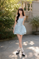 Three-quarter view of VOGSION baby blue bubble hem mini dress
