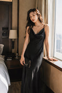 Black wedding guest maxi dress with adjustable spaghetti straps and a fluid column silhouette
