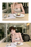 Woman in a Vogsion Élodie Bow-Tiered Ivory Lace Maxi Dress sitting at a table with a dessert, in two different poses.