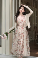 Vogsion Elysian Rose floral maxi dress worn by customer in a sunlit garden
