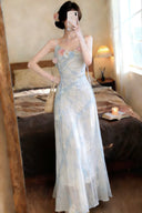 Woman in a Vogsion Odette ethereal 3D floral watercolor mesh maxi dress taking a mirror selfie in a bedroom.