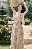 Vogsion Elysian Rose floral maxi dress worn by customer in a sunlit garden