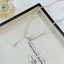 Vogsion Céleste Pearl Lariat Necklace with pearls and a sentimental message on a white box