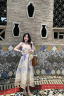 Vogsion Dawning Floral Corset Midi Dress featuring a blue and white boho floral pattern and tie straps, shown on a customer in a scenic vacation setting