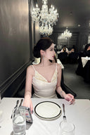 Vogsion Aurelia white corset dress with 3D floral tulle skirt on customer at luxury dinner, 2026 fashion trends.
