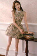 Parisian vintage-inspired outfit with floral mini dress and contrast collar, exuding timeless elegance and innocence
