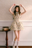 Sleeveless rose jacquard mini dress with vintage floral texture and A-line silhouette, styled with white socks and ballet shoes