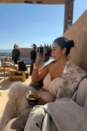 Woman sitting on a couch with a scenic background