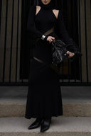 Vogsion x Nophora Obsidian Ecliptic Avant-Garde Maxi Gown worn by a customer, featuring black turtleneck, shoulder cut-outs, and diagonal sheer mesh panels.