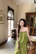 VOGSION Luna Lace Bandeau Gown in Pistachio green lace, featuring a strapless plunging neckline and braided detailing, modeled by a Vogsion custome