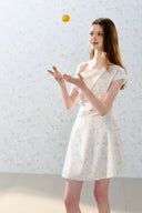 Romantic off-shoulder floral mini dress by Vogsion, pastel flower pattern, A-line silhouette, soft feminine French style perfect for spring and summer days.