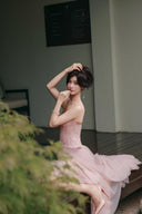 Vogsion soft pink lace corset maxi dress seated portrait with tulle skirt