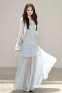 Vogsion customer wearing the Céleste light blue floral tiered tulle maxi dress with sheer skirt and romantic aesthetic for high-end summer fashion.