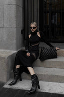 Vogsion x Nophora Obsidian Ecliptic Avant-Garde Maxi Gown worn by a customer, featuring black turtleneck, shoulder cut-outs, and diagonal sheer mesh panels.