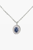 Silver necklace with a blue gemstone pendant on a white background
