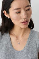 Woman wearing a Vogsion Darcy Reverie Oval Gemstone Pendant Necklace with a white background