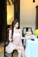 Woman in a Vogsion Odette Pearl-Trim Bubble Mini sitting at a table in a restaurant setting