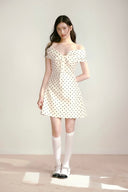 Vogsion La Jolie Noire Bow Polka Dress — off-shoulder ivory satin mini dress with black polka dots and oversized bow, vintage Parisian style