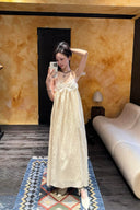 Vogsion Santorini Scalloped Lace Maxi Dress in cream, featuring delicate floral lace bust detailing and a fluid, floor-length silhouette.