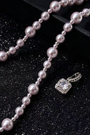 The Vogsion "Blush Radiance" Pearl & Crystal Pendant Necklace with a matching pendant on a black glittery background