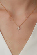     Close-up of Vogsion oval synthetic moissanite pendant necklace with gold-tone chain and delicate pavé-style connector.