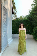 VOGSION Luna Lace Bandeau Gown in Pistachio green lace, featuring a strapless plunging neckline and braided detailing, modeled by a Vogsion custome