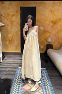 Vogsion Santorini Scalloped Lace Maxi Dress in cream, featuring delicate floral lace bust detailing and a fluid, floor-length silhouette.