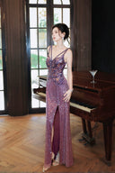 Woman in a Vogsion "Midnight Butterfly" Iridescent Sequin Backless Evening Gown standing in a room with a piano.