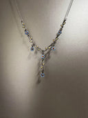 Necklace with floral design on a plain background