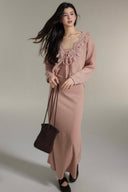 Side view of Vogsion powder pink matching knit set: lace-trimmed cardigan and flowy maxi skirt on genuine customer, soft knit fabric, elegant co-ord for spring summer 2026, real woman styling