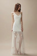 Vogsion Aurelia white corset dress with 3D floral tulle skirt on customer at luxury dinner, 2026 fashion trends.