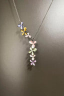 Necklace with floral pendant on a plain background