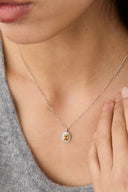 Vogsion Darcy Reverie Oval Gemstone Pendant Necklace worn by a person, focusing on the jewelry.