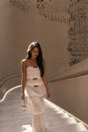  Vogsion Élodie Bow-Tiered Ivory Lace Maxi Dress worn by customer on warm-lit staircase