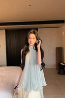 Vogsion Elysian Tiered Pleated Chiffon Maxi Dress in soft seafoam blue – flowy vacation resort wear summer maxi dress with tiered ruffles, worn by real customer on yacht, lightweight pleated chiffon elegant beach dress with global fast shipping