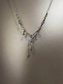 Delicate necklace with floral designs on a neutral background