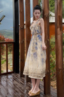 Vogsion Dawning Floral Corset Midi Dress featuring a blue and white boho floral pattern and tie straps, shown on a customer in a scenic vacation setting