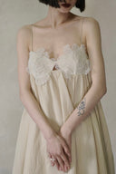Vogsion Santorini Scalloped Lace Maxi Dress in cream, featuring delicate floral lace bust detailing and a fluid, floor-length silhouette.