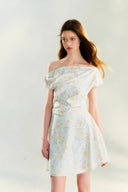 Romantic off-shoulder floral mini dress by Vogsion, pastel flower pattern, A-line silhouette, soft feminine French style perfect for spring and summer days.