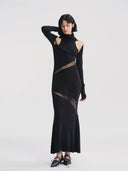 Vogsion x Nophora Obsidian Ecliptic Avant-Garde Maxi Gown worn by a customer, featuring black turtleneck, shoulder cut-outs, and diagonal sheer mesh panels.