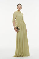 Woman wearing a Vogsion Light Pomelo Olive Mesh Knit Draped Cape Pleated Maxi Dress with a draped effect on a white background