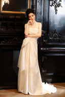 Woman in a Vogsion 2026 3D Blooming Rose Strapless Ruched Pleated Wedding Dress standing in an elegant room with dark wood paneling.