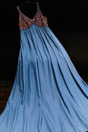 Blue dress with brown lace top on a dark background
