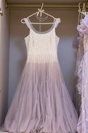     Vogsion Moonlit Lavender Petal ivory and lavender tulle midi dress hanging on pearl hanger, showing textured bodice and layered skirt