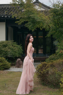 Vogsion blush corset tulle maxi dress outdoor garden walkway full body shot