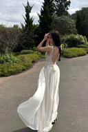 Woman in a Vogsion Amber Light Lace Spliced Open Back Tie Strap Maxi Dress standing on a path with greenery in the background